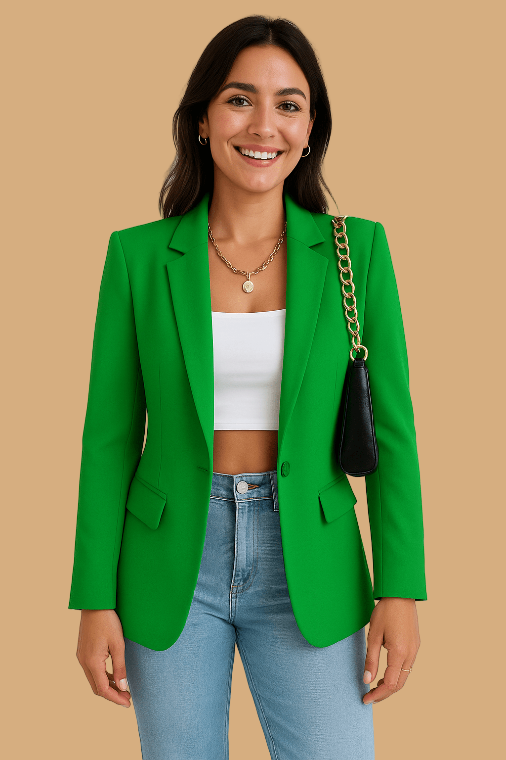 Woman wearing a green blazer, white top, and blue jeans on a plain background